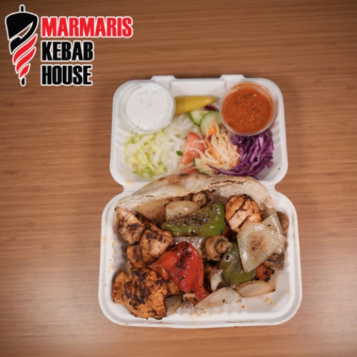 Marmaris Kebab House box with chicken kebabs, peppers, sauces, salad, and bread.